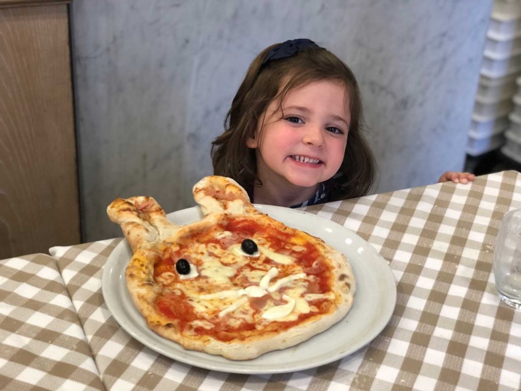 Little girls with her pizza during a cooking class in Rome.