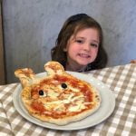 Little girls with her pizza during a cooking class in Rome.