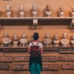 Girl in front of Roman statues at Vatican Museums during a tour with Rome for kids